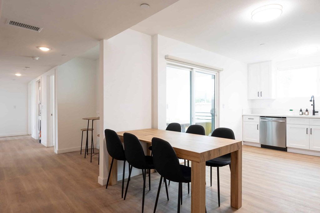 A dining table with four chairs is in the middle of a room.
