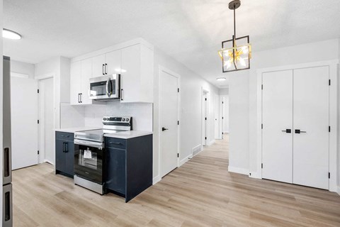 A kitchen with a microwave on the counter.