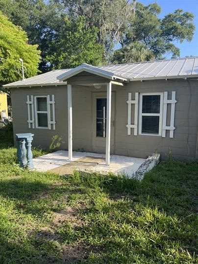 A small house with a porch and a covered entrance.