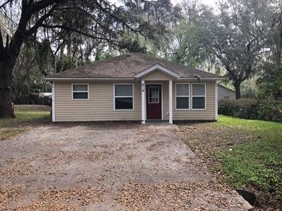 A small house with a brown door and a brown roof.