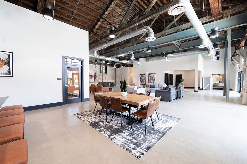 A conference room with a long table surrounded by chairs.
