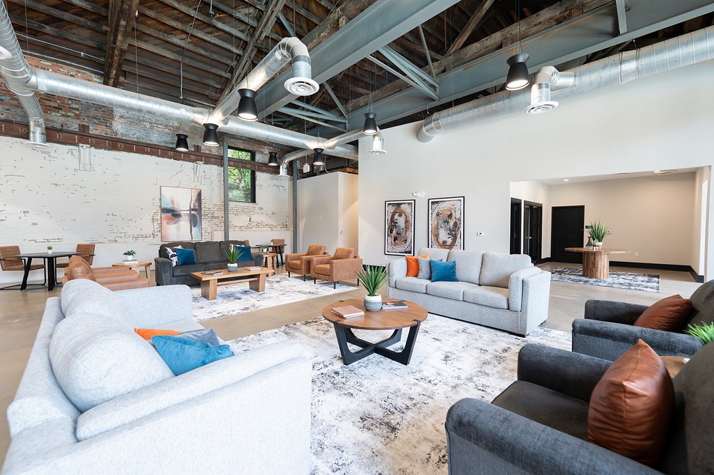A living room with a white couch and a coffee table.