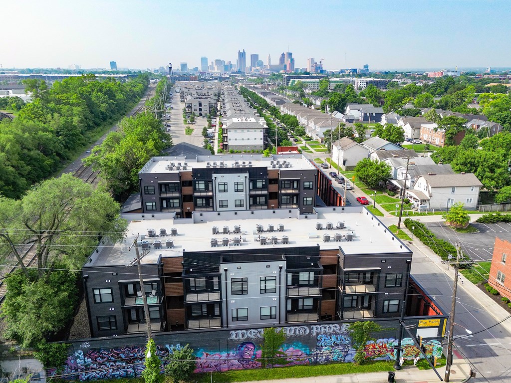 A kitchen with a sink, refrigerator, and cabinets.