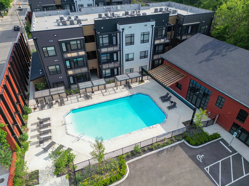 A room with a carpeted floor and a window with blinds.