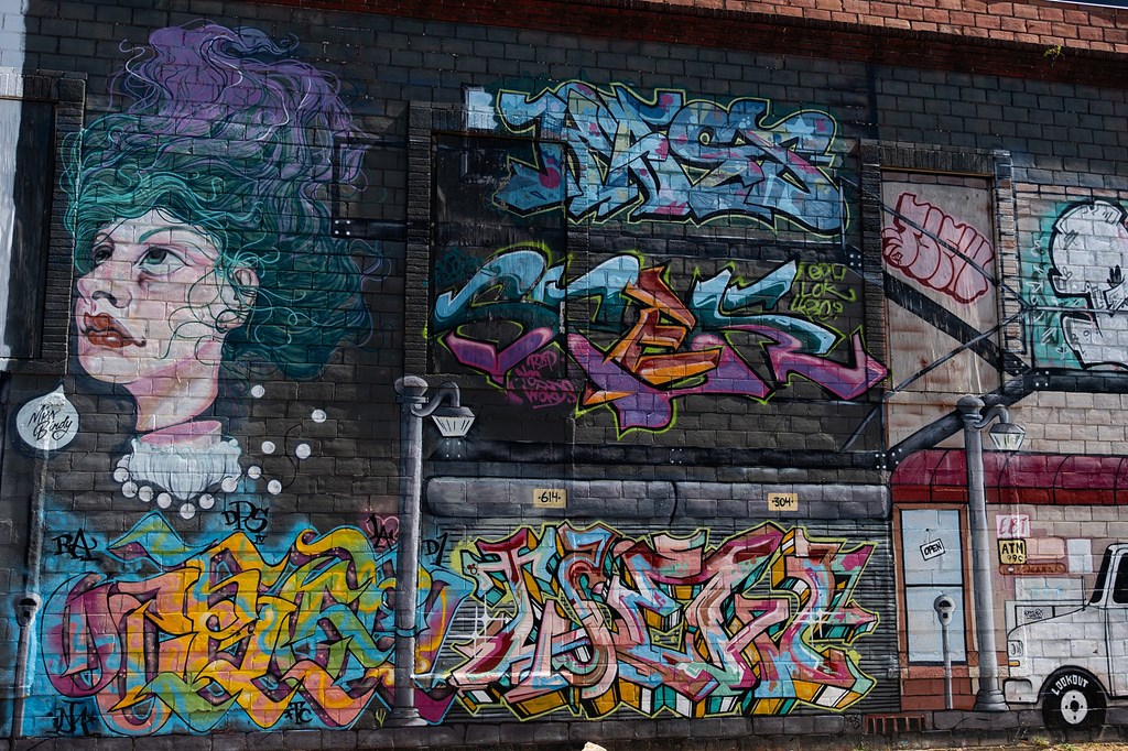 A white toilet in a small bathroom with a white tiled wall.
