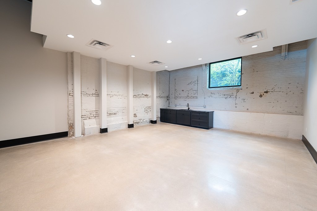 A modern apartment complex with a parking lot in front.