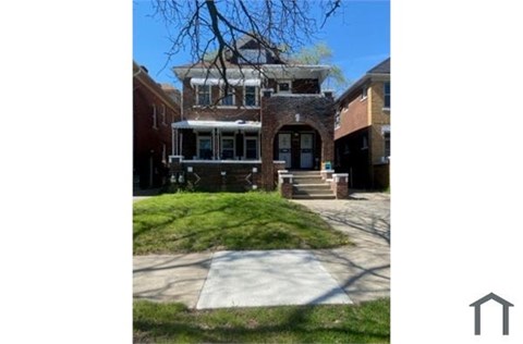 A house with a brick facade and a large front porch.