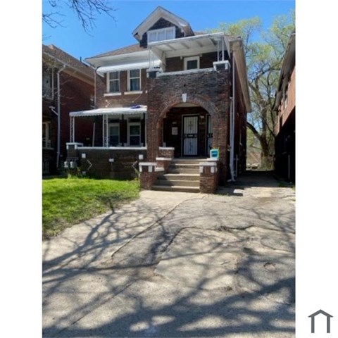 A house with a brick facade and a white roof.