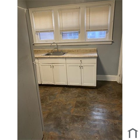 A kitchen with a sink and cabinets.