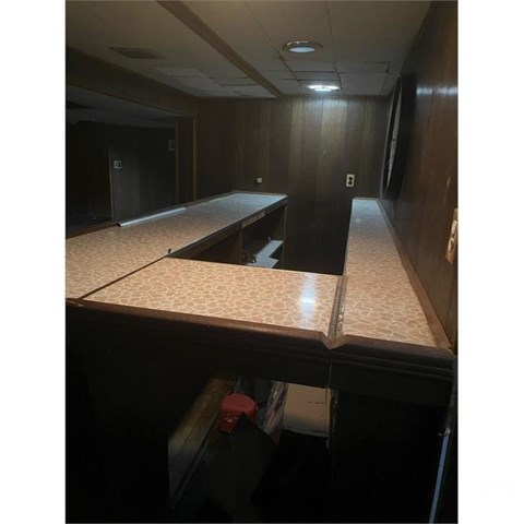 A long, empty hallway with a bench at the end.