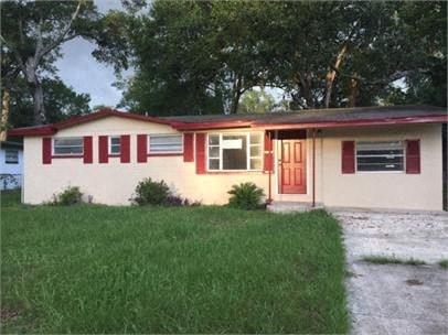 A house with red and white trim and a red door.