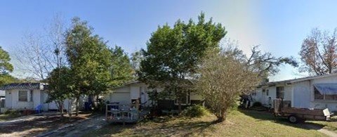 A sunny day at a mobile home park with a rainbow in the sky.