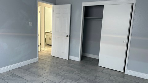 A white door is open in a room with grey walls.