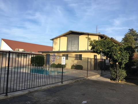 A house with a pool in front of it.