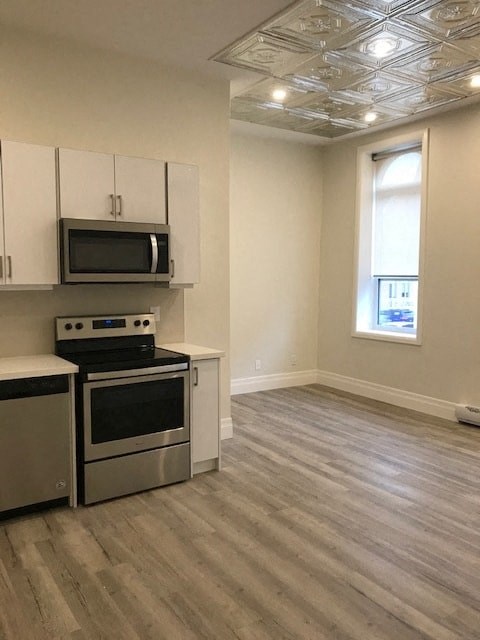 A kitchen with a stove top oven and microwave above it.