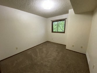 A room with a window and a concrete floor.