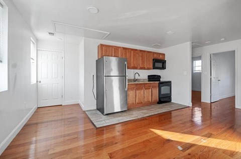 A kitchen with a wooden countertop and a stainless steel refrigerator.