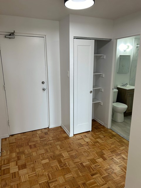 A bathroom with a toilet and a shower stall.