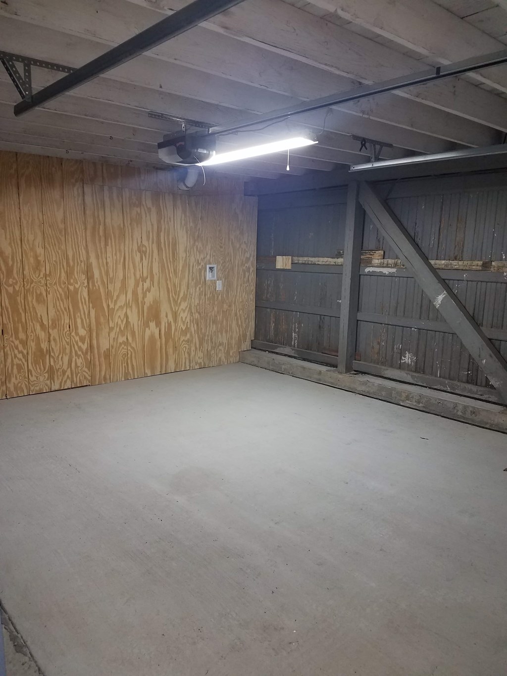 A large empty room with a light on the ceiling.