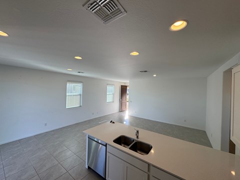 A kitchen with a sink and a dishwasher.