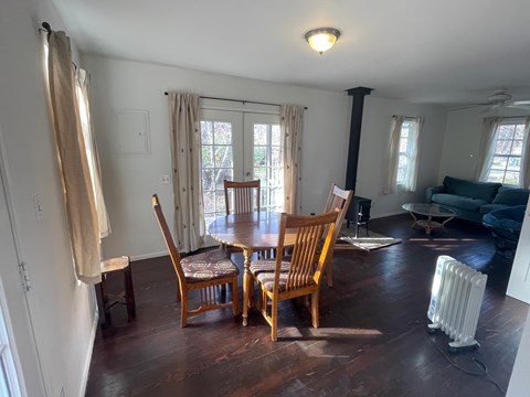A room with a table and chairs in it.