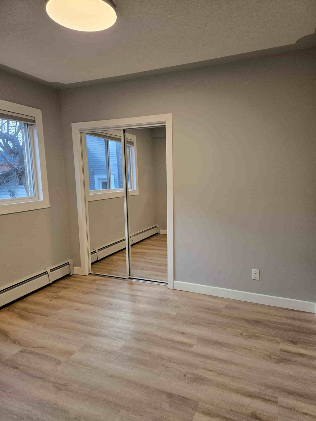 A room with a sliding door and a window.