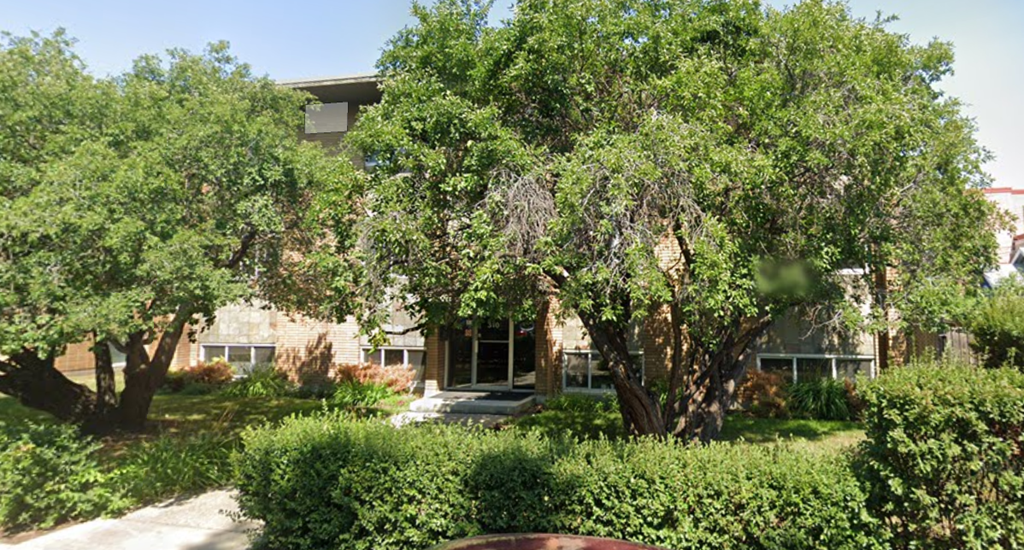 A house with a tree in front of it.