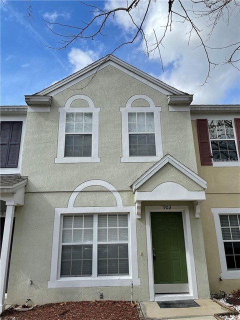 A house with a green door and white windows.