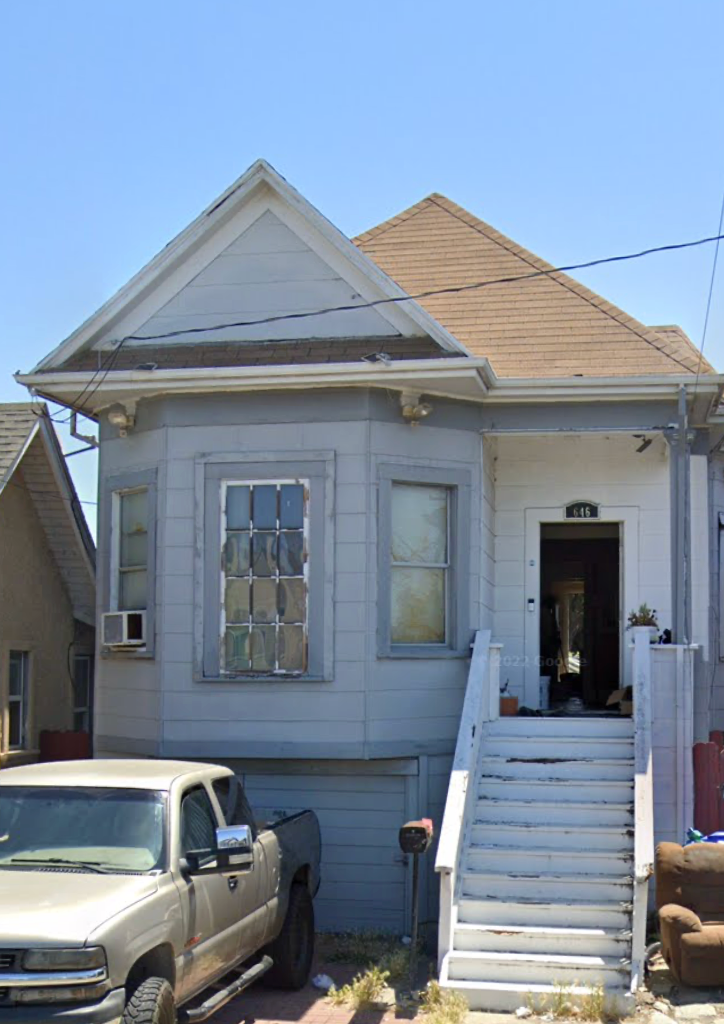 A house with a truck parked in front.
