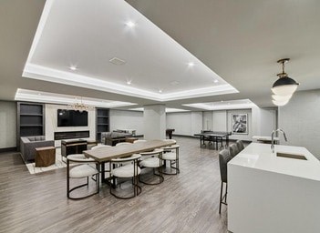 A modern kitchen with a dining table and chairs.
