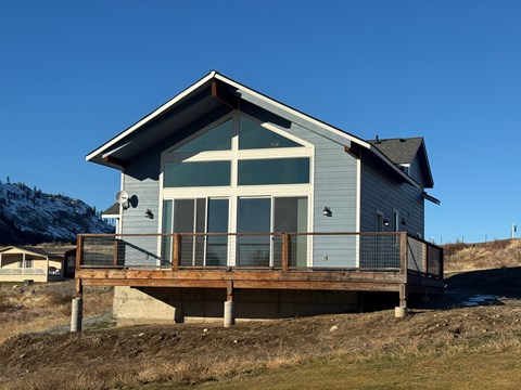 A house with a grey roof and a balcony.