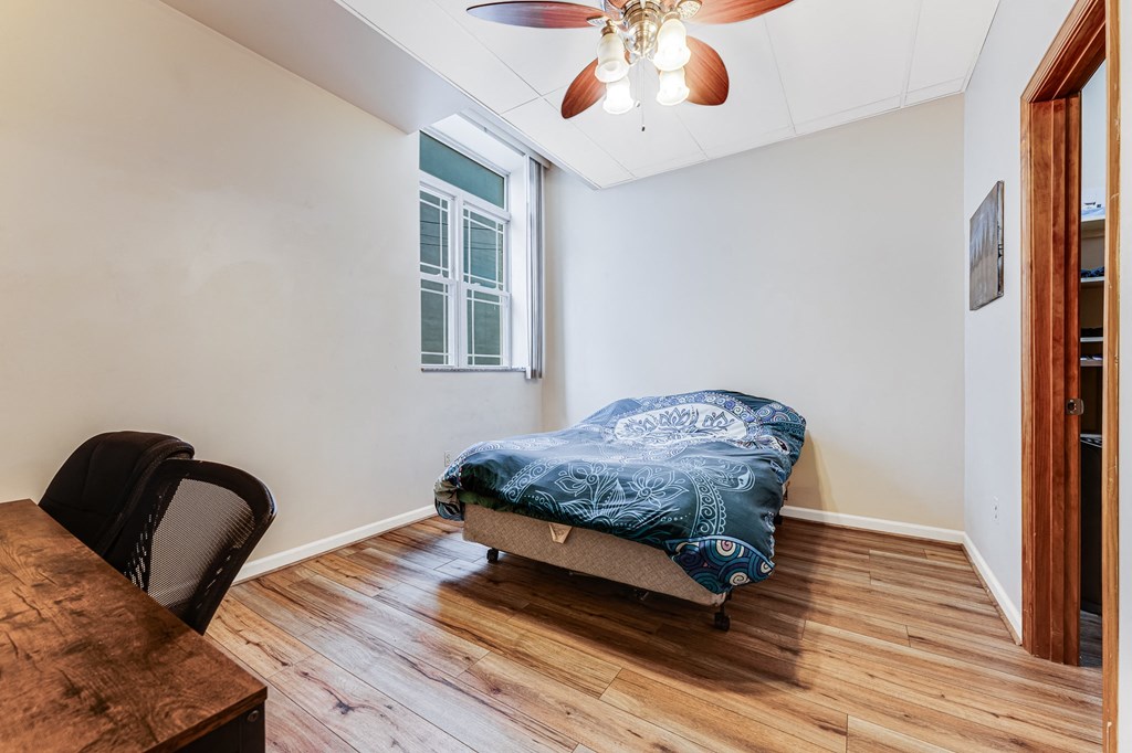 A room with a bed and a chair.