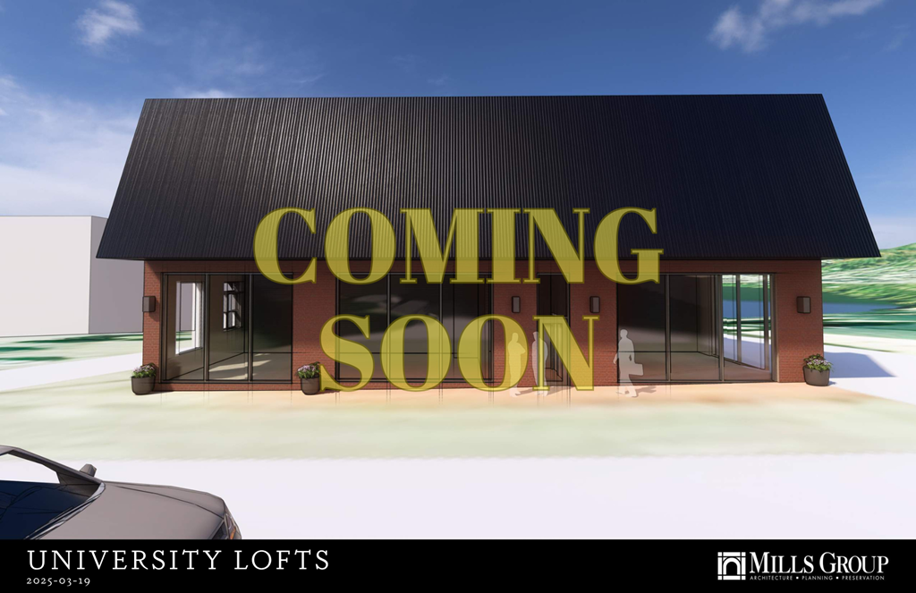 A modern building with a black roof and glass doors is under construction, with a sign that reads "COMING SOON".