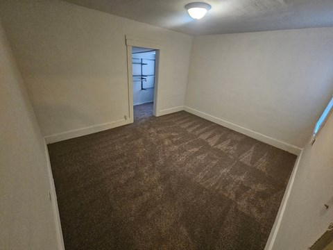 A room with brown carpet and white walls.