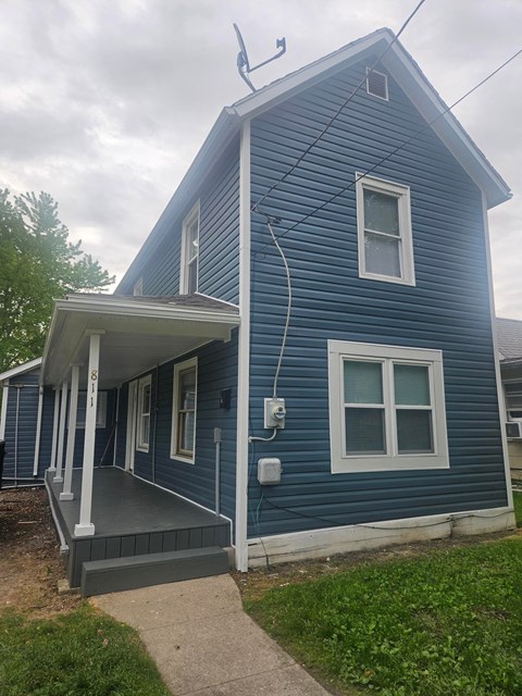 A blue house with a white porch.