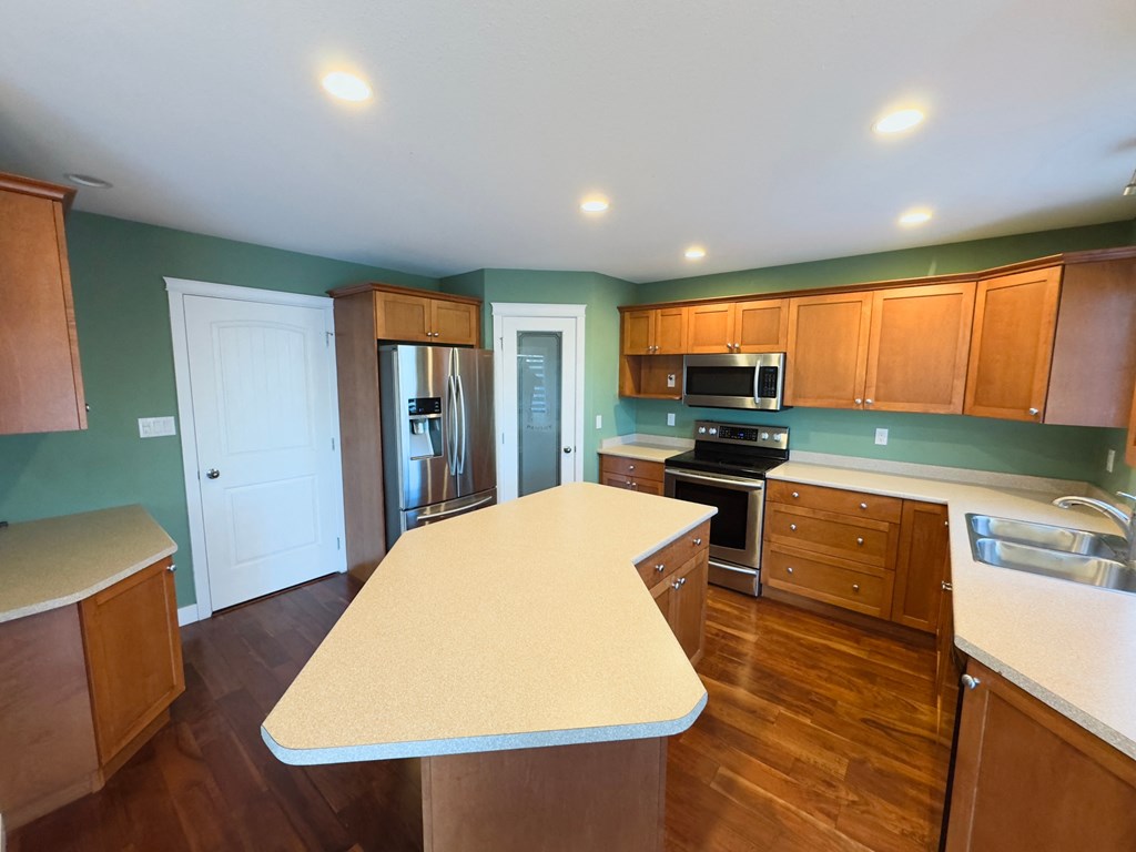 A kitchen with a long island in the middle.