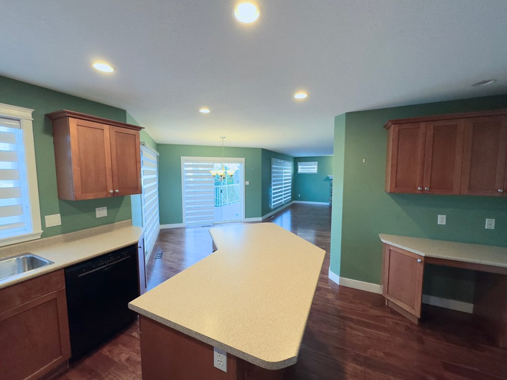 A kitchen with a long counter and cabinets.