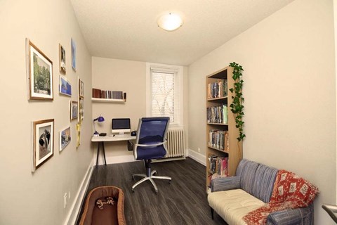 A cozy room with a couch, chair, and bookshelf.
