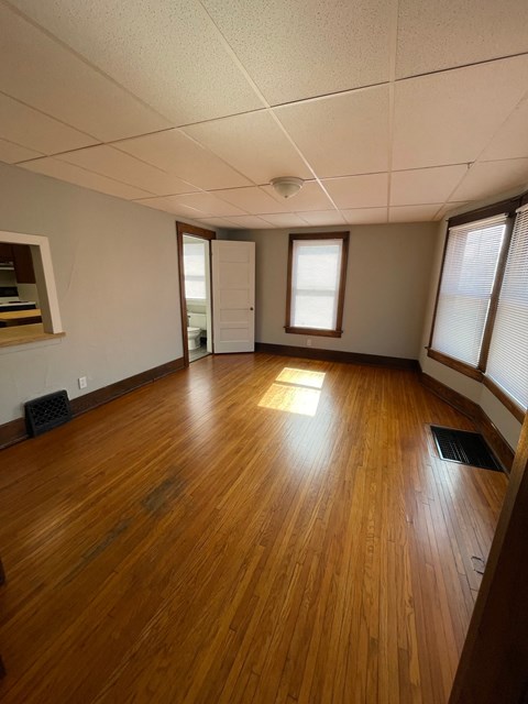 A room with wooden floors and a window.