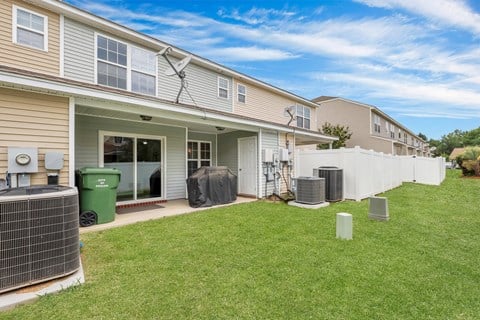 A sunny day at a residential area with houses and green lawns.