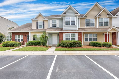 A row of houses with a clear blue sky above them.