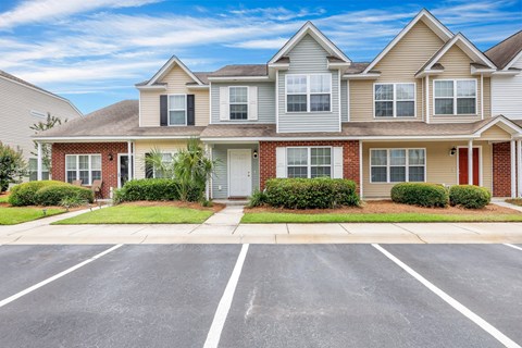 A row of houses with a clear blue sky above them.