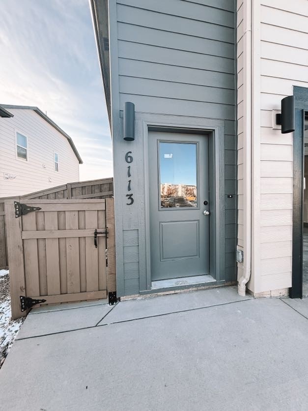 A grey door with the number 6113 on it.