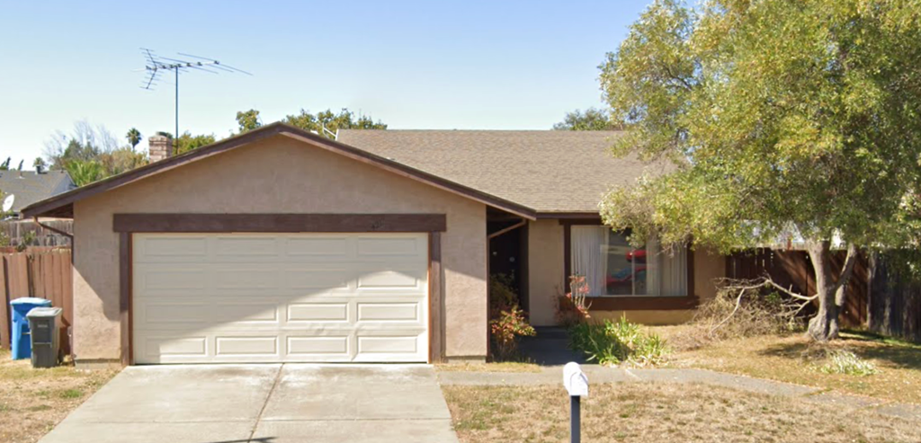 A house with a brown roof and a white garage door.