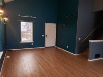 A room with a wooden floor and a white door.