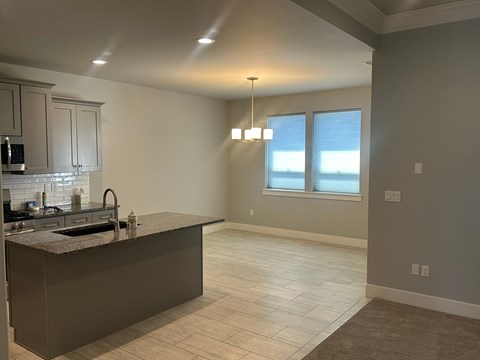 A kitchen with a large island and a window.