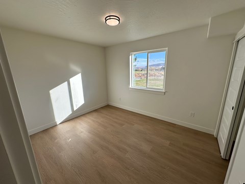A room with a window and a door.