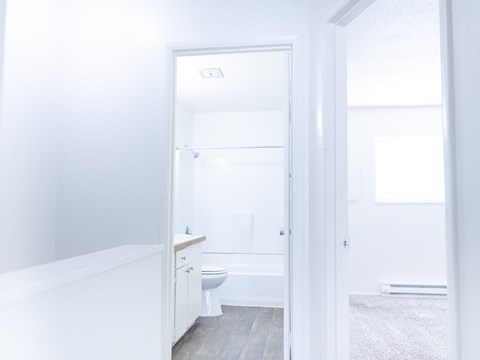 A white bathroom with a toilet and sink.