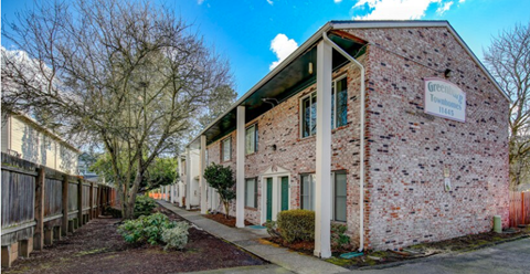 A building with a sign that says "Greatwood Village" is shown.