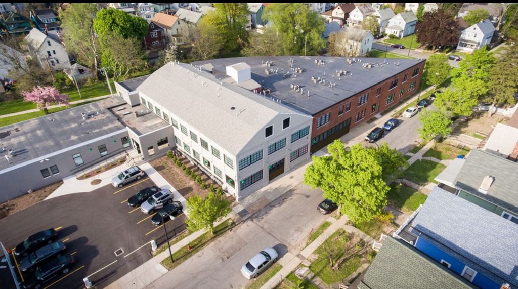 A parking lot with cars and a building in the background.